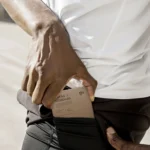 Momax Qi2 magnetic wireless power bank securely attached to MagSafe iPhone